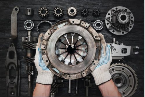 Hands holding a circular object with a group of gears and a couple of hands